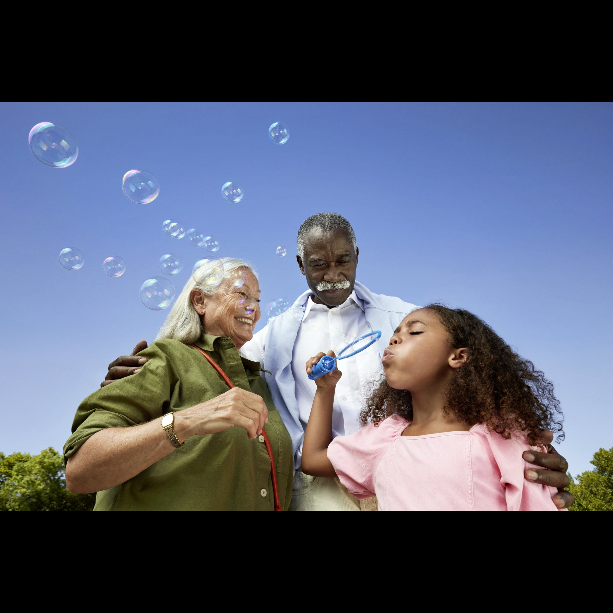 Close-up of hands gently resting together, showing connection and support, with colorful bracelets visible on the wrist.